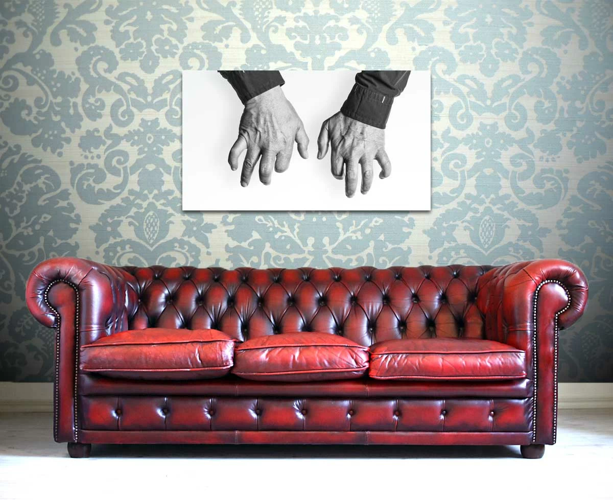 Picture of Joachim Kühn's HANDS over a red sofa.